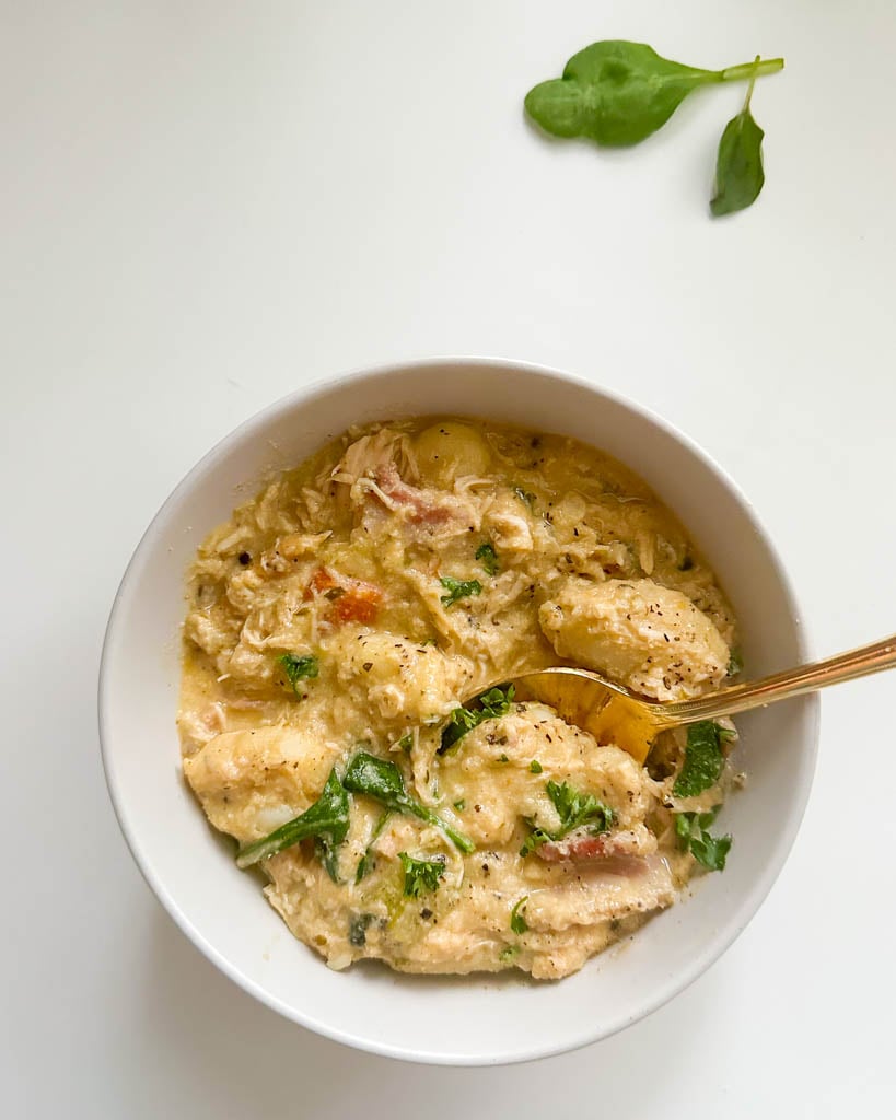 a small white bowl of dairy free chicken gnocchi soup