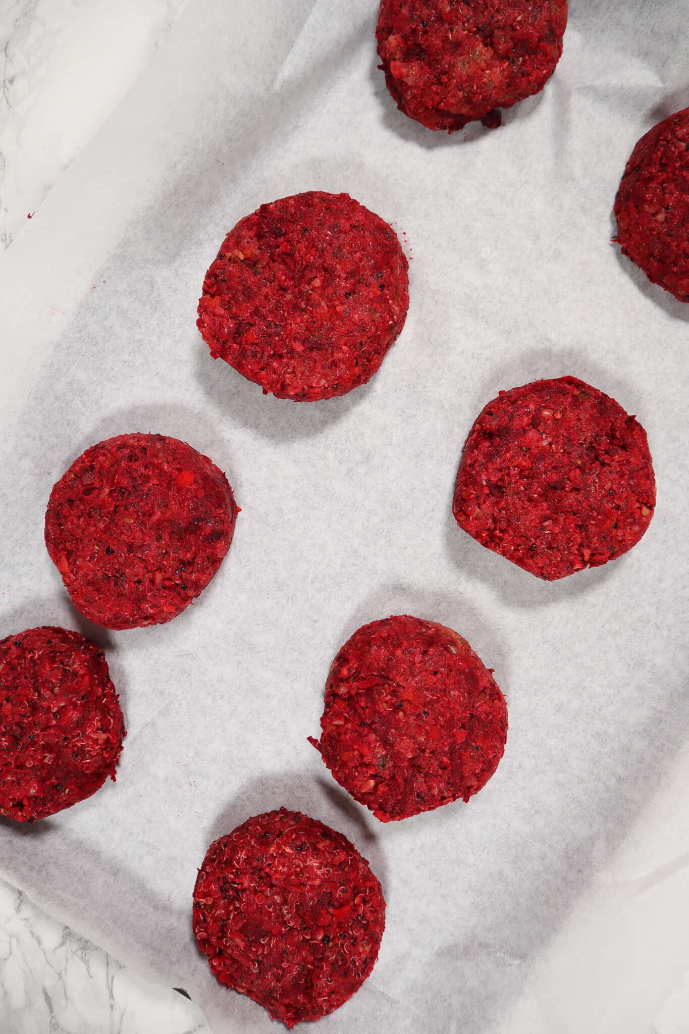 beet burger patties on a tray lined with parchment paper
