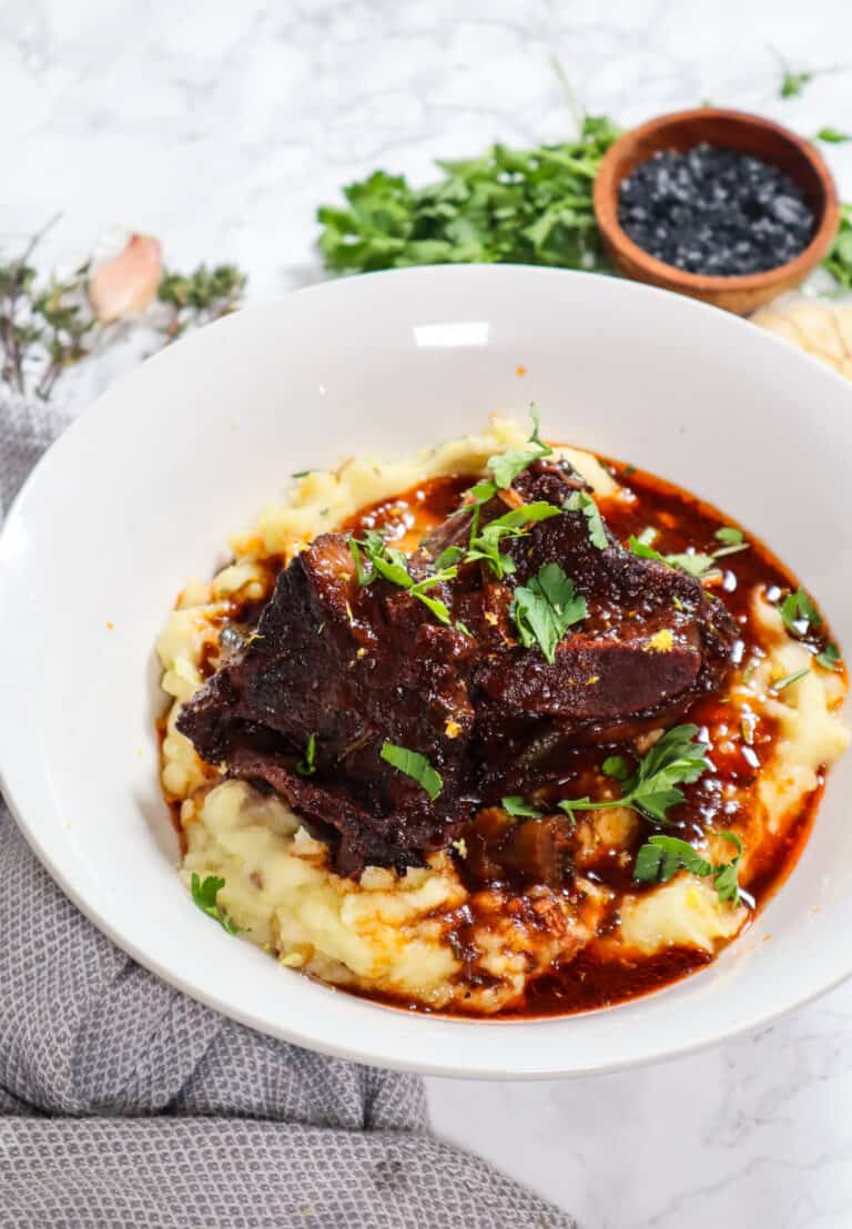 braised short ribs over creamy mashed potatoes, served in a large bowl