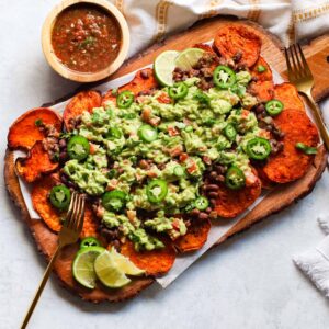 sweet potato nachos topped with guacamole beans and salsa