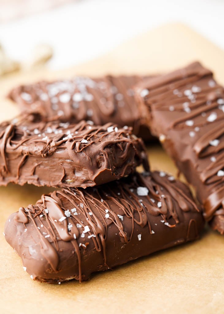 four vegan ice cream snickers bars on parchment paper