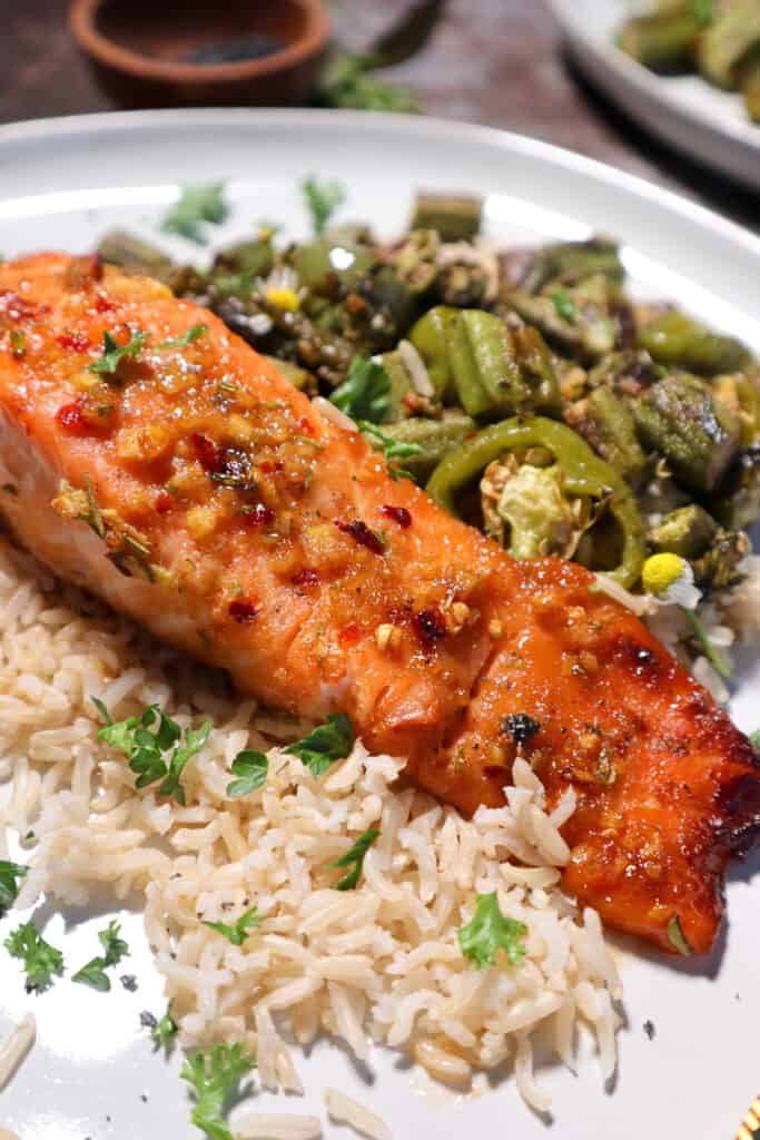 Plated Maple Ginger Glazed Salmon with rice and okra.