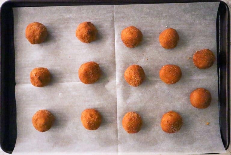 gluten free snickerdoodle pumpkin cookies before baking on a parchment lined baking sheet