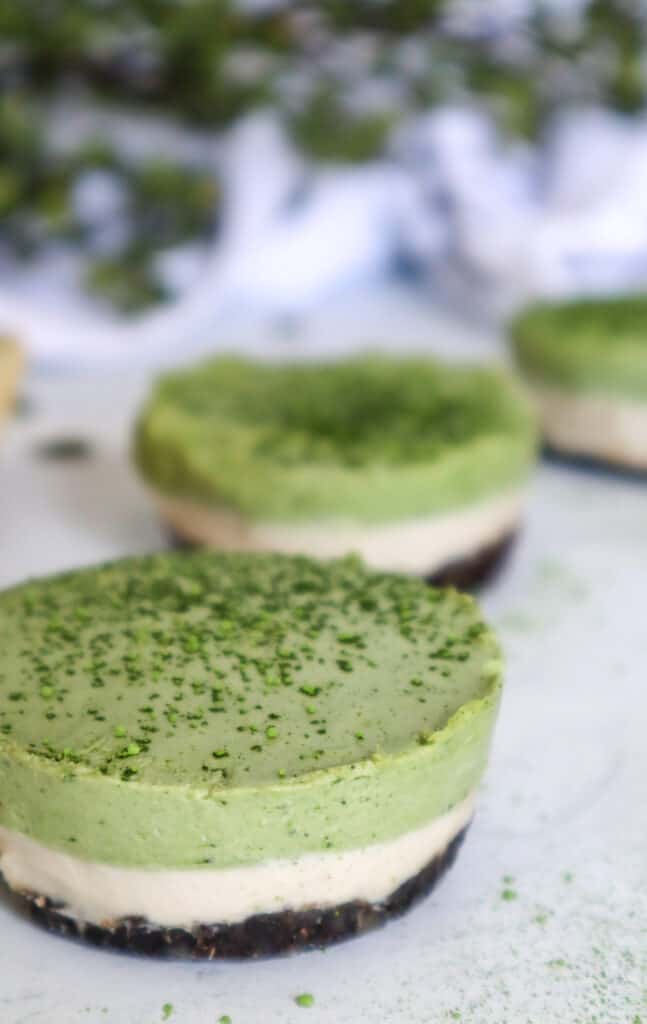 A close up image of Mini Matcha Cheesecakes 
