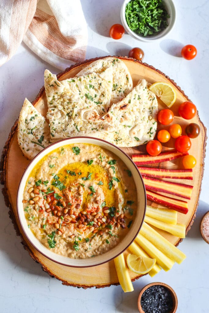 baba ganoush served with carrots tomatoes and pita bread