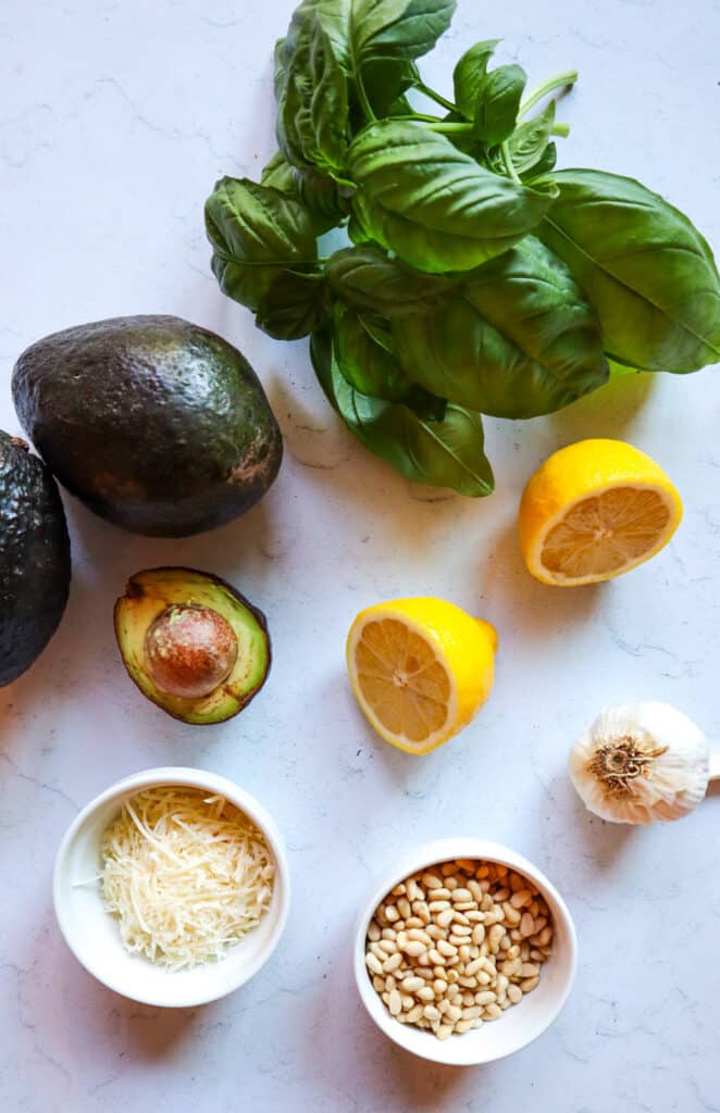 Ingredients to make creamy avocado pesto 
