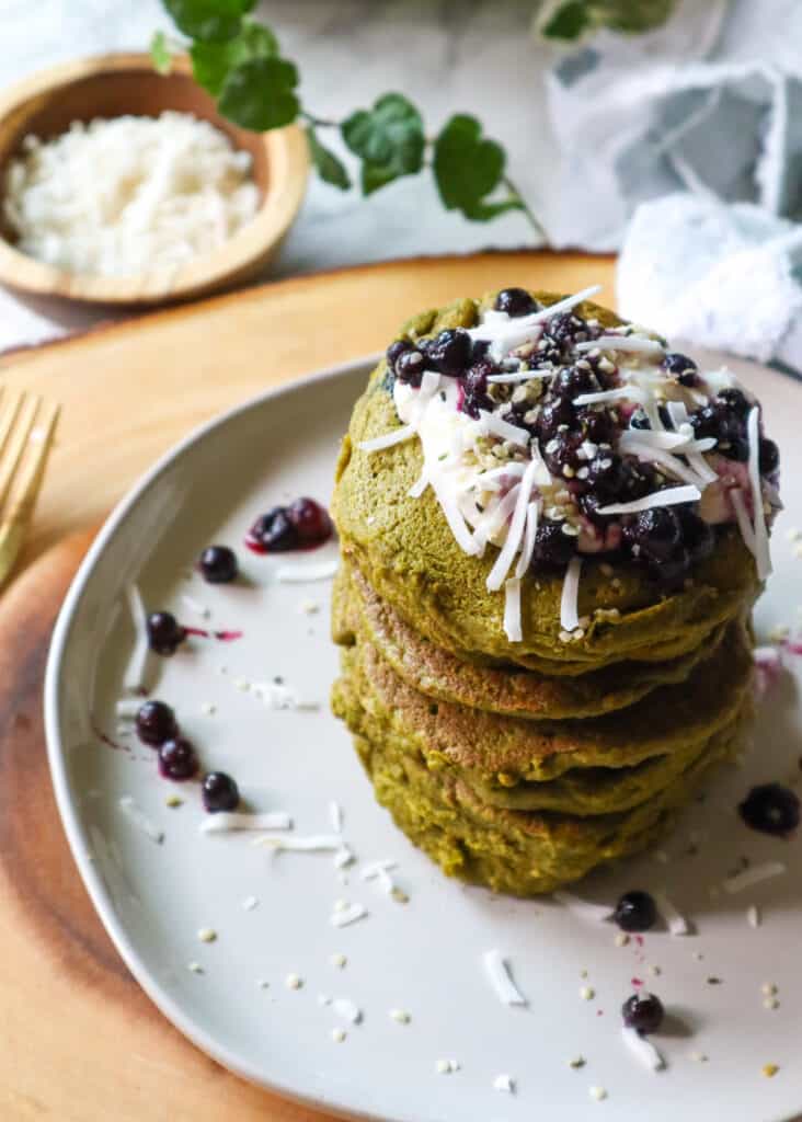 Moringa fluffy pancakes toped with blueberries, coconut, hemp seeds