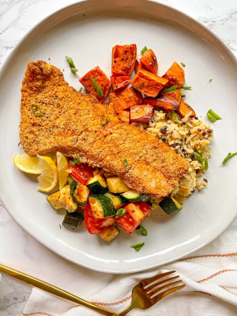 Crispy Gluten-Free Air Fryer Fish served over rice with potatoes and vegetables
