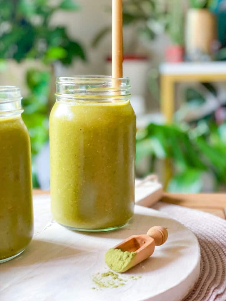 Moringa Papaya Smoothie with a close up of moringa powder next to the smoothie