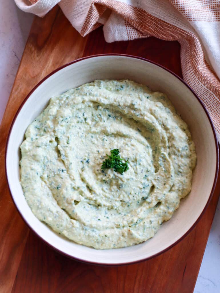 Vegan Ricotta Cheese in a white bowl on a cutting board