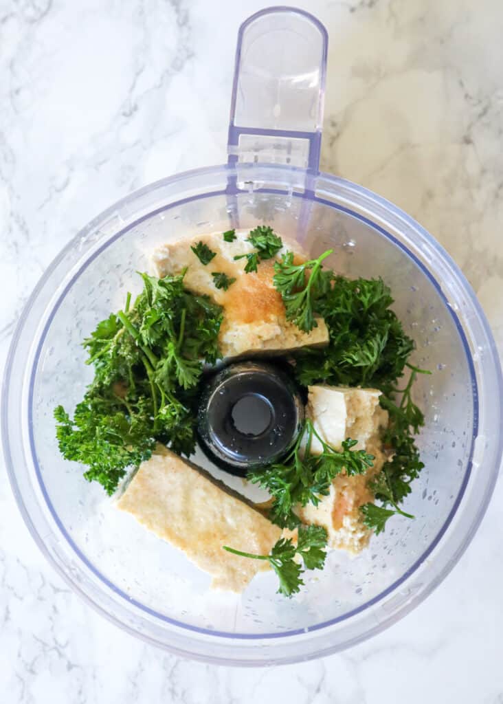 ingredients to make tofu ricotta shown in a food processor