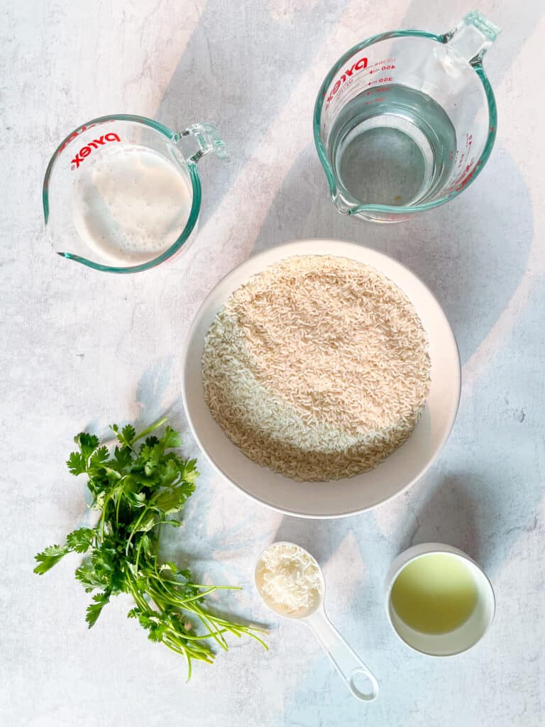 ingredients to make coconut cilantro lime rice: cilantro, coconut milk, water, lime juice, shredded coconut, rice