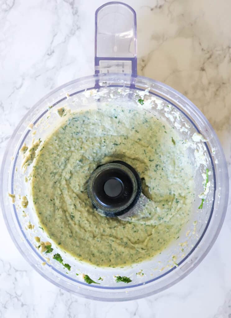 Ingredients blended. creamy vegan tofu ricotta in the food processor shown