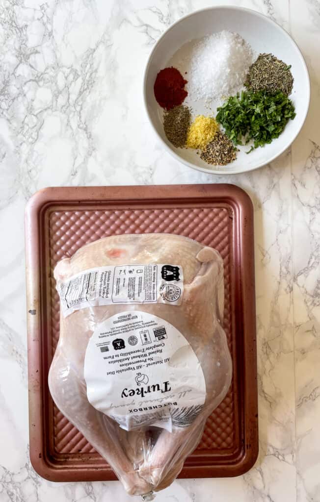 Ingredients to make dry-brined spatchcock turkey: Whole Turkey and dry bring: seasonings, salt and fresh herbs