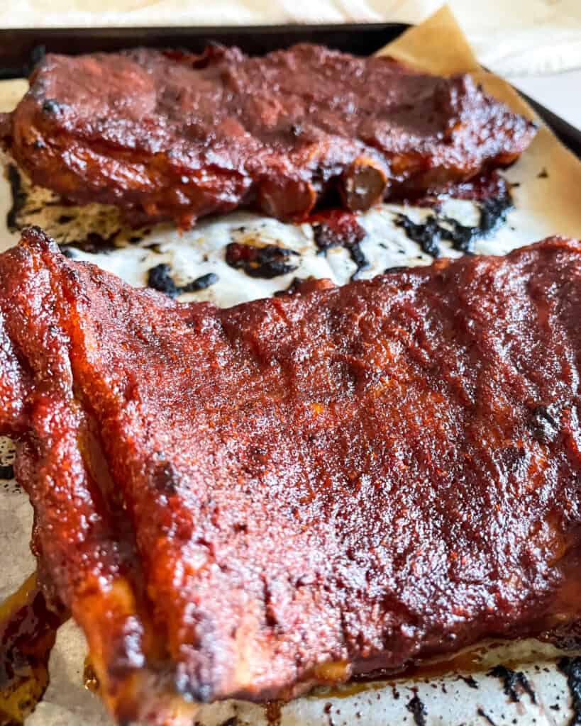 Close up view of Instant Pot Ribs out of the broiler with barbecue sauce caramelized.