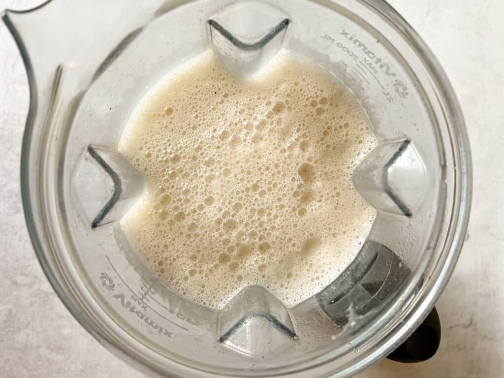 eggnog mixture in blender after adding in coconut milk