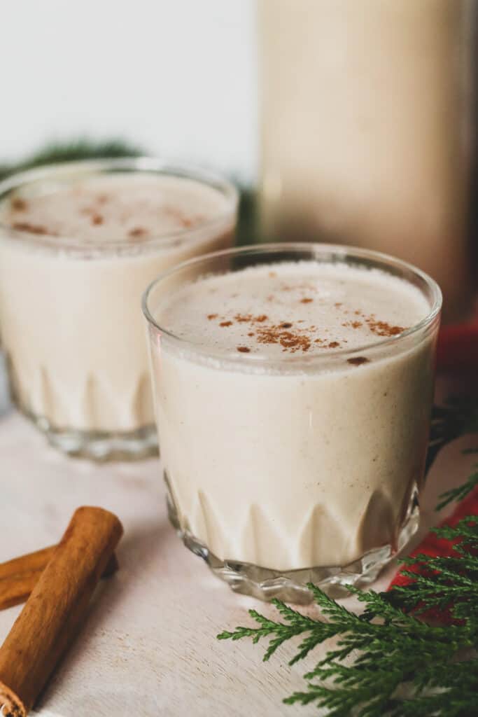 two glasses of dairy free eggnog made with coconut milk and almond milk