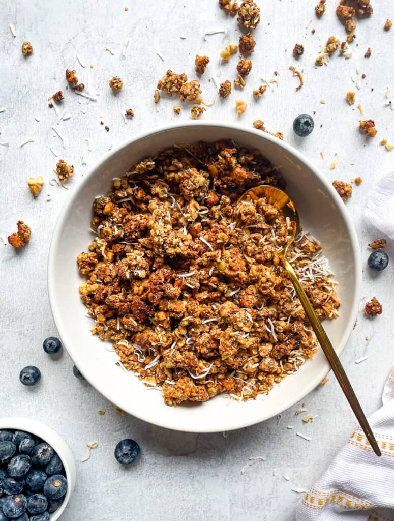 Date sweetened Grain-free granola in a large bowl with blueberries on the side