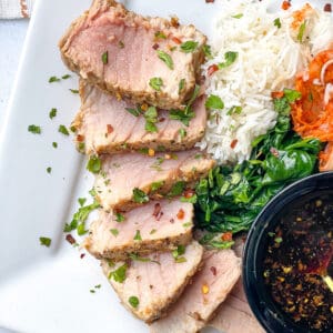 plated ahi tuna steak served with dipping sauce, spinach, rice, and kimchi