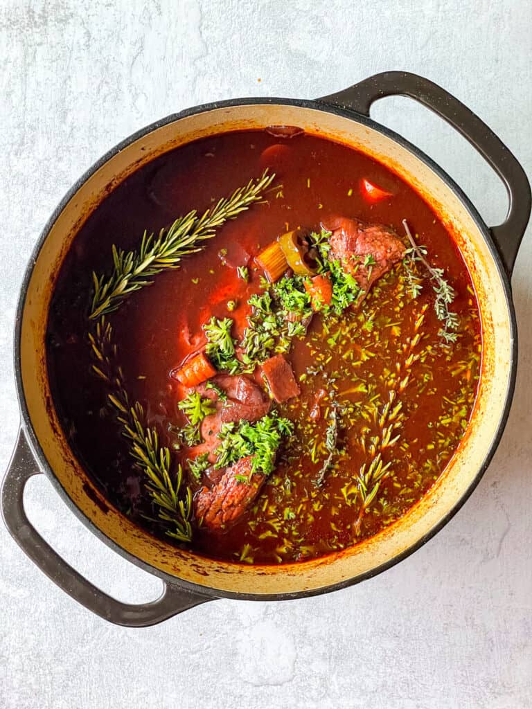 oven braised beef brisket with herbs in a dutch oven