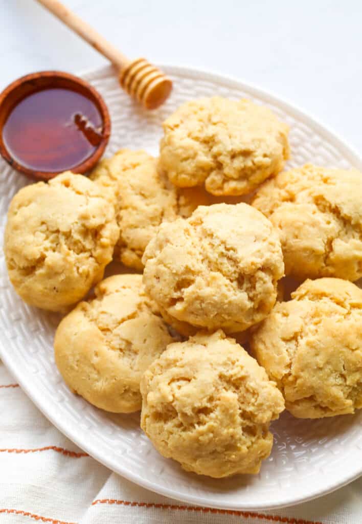 plate of vegan gluten free buttermilk biscuits served with honey