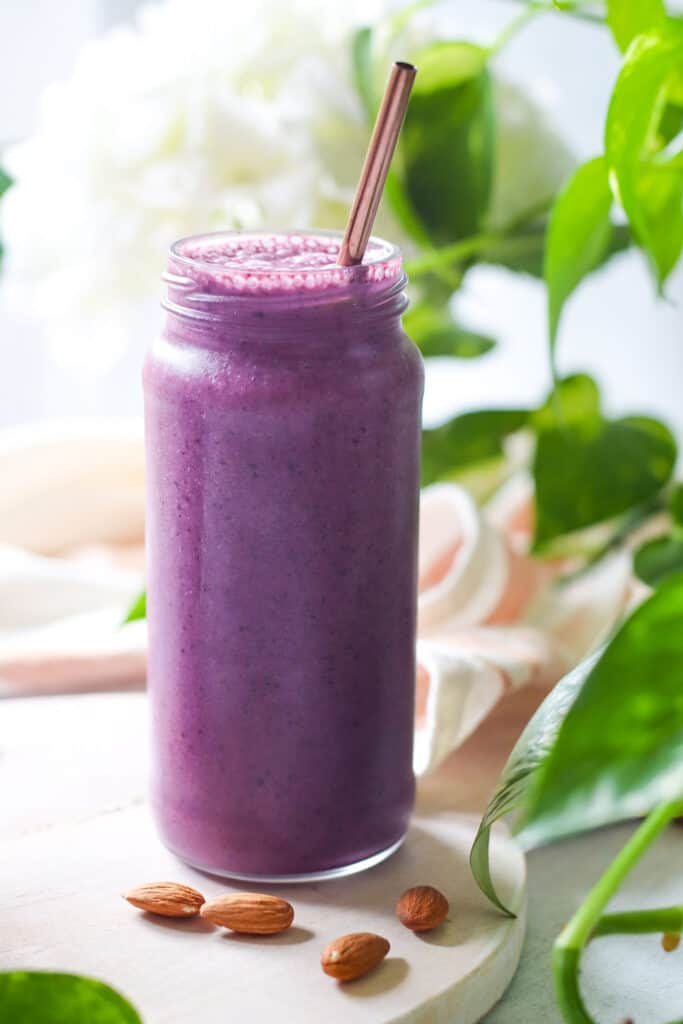 Sea Moss Smoothie With Blueberries, banana, almond butter, and nondairy milk. smoothie shown in mason jar
