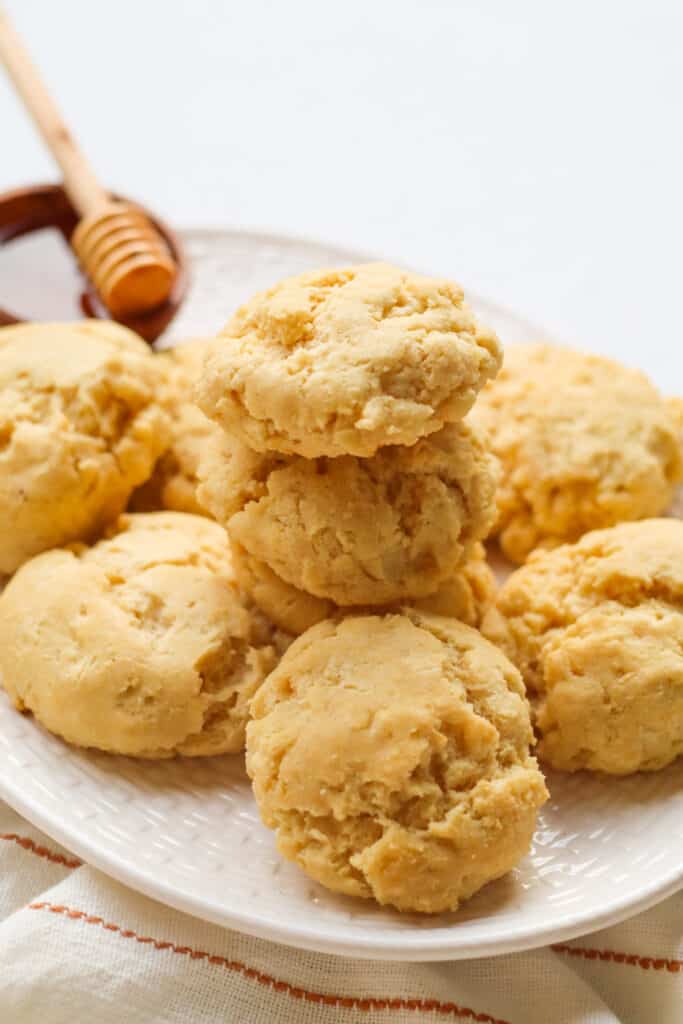 plate of vegan gluten free buttermilk biscuits served with honey