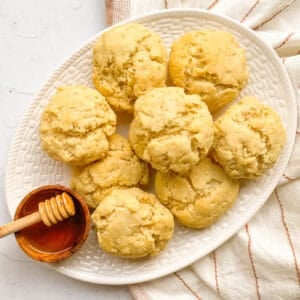 plate of gluten free buttermilk biscuits with a side of honey