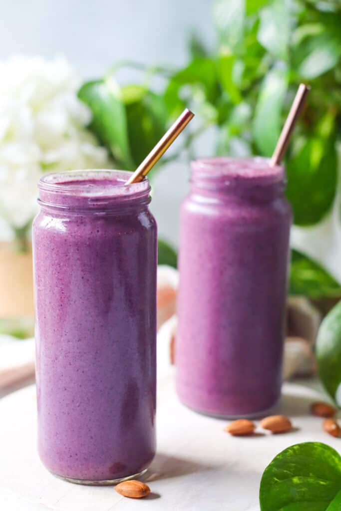 Two Blueberry Almond Sea Moss Smoothies shown in mason jars. 
