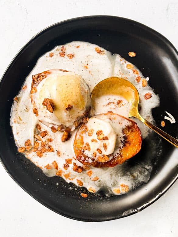 peaches made in the air fryer and topped with ice cream granola cinnamon and honey for dessert