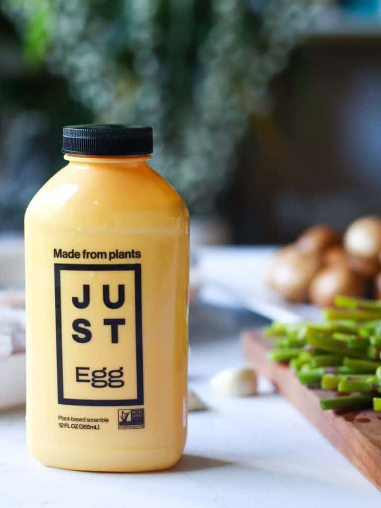 bottle of just egg and sliced veggies in background