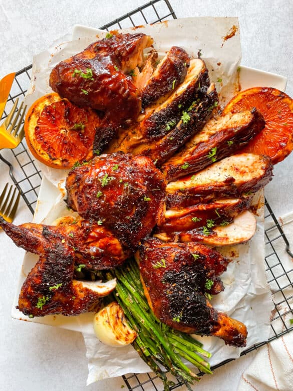 a whole grilled chicken carved for serving