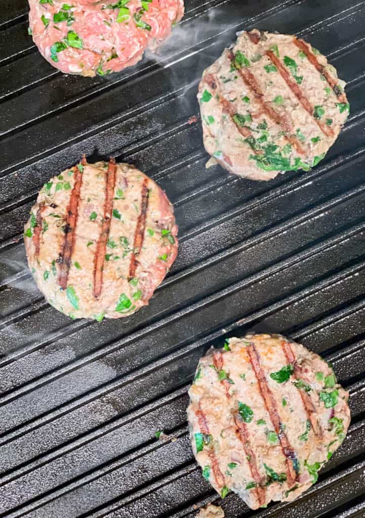 lamb patties cooking on the grill