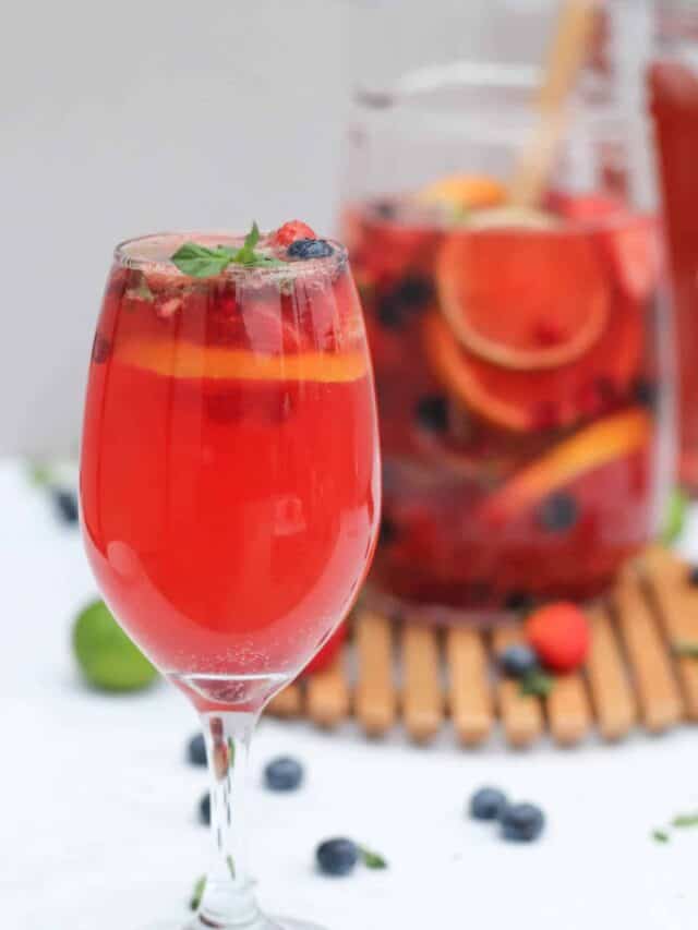 close up of glass of sangria made with rose and fresh fruit