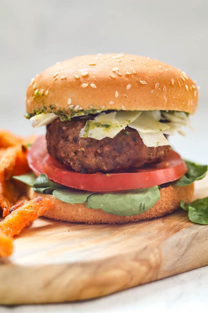 Air Fryer Turkey Burger on a Gluten-Free Bun With Pesto, Fresh Grated Parmesan, Tomato, and Lettuce. Served with Sweet Potato Fries