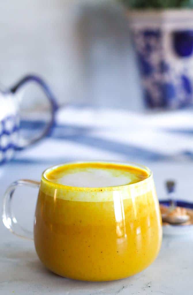 a glass mug filled with turmeric maca latte