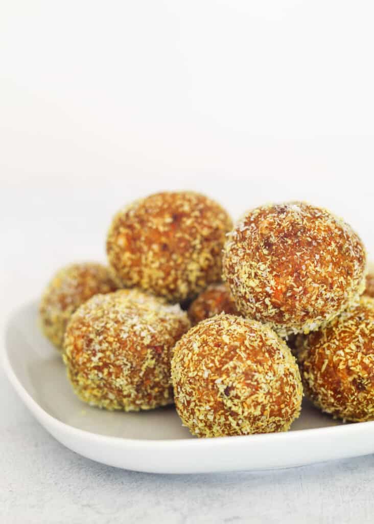 seven Turmeric Balls on a small white plate sitting