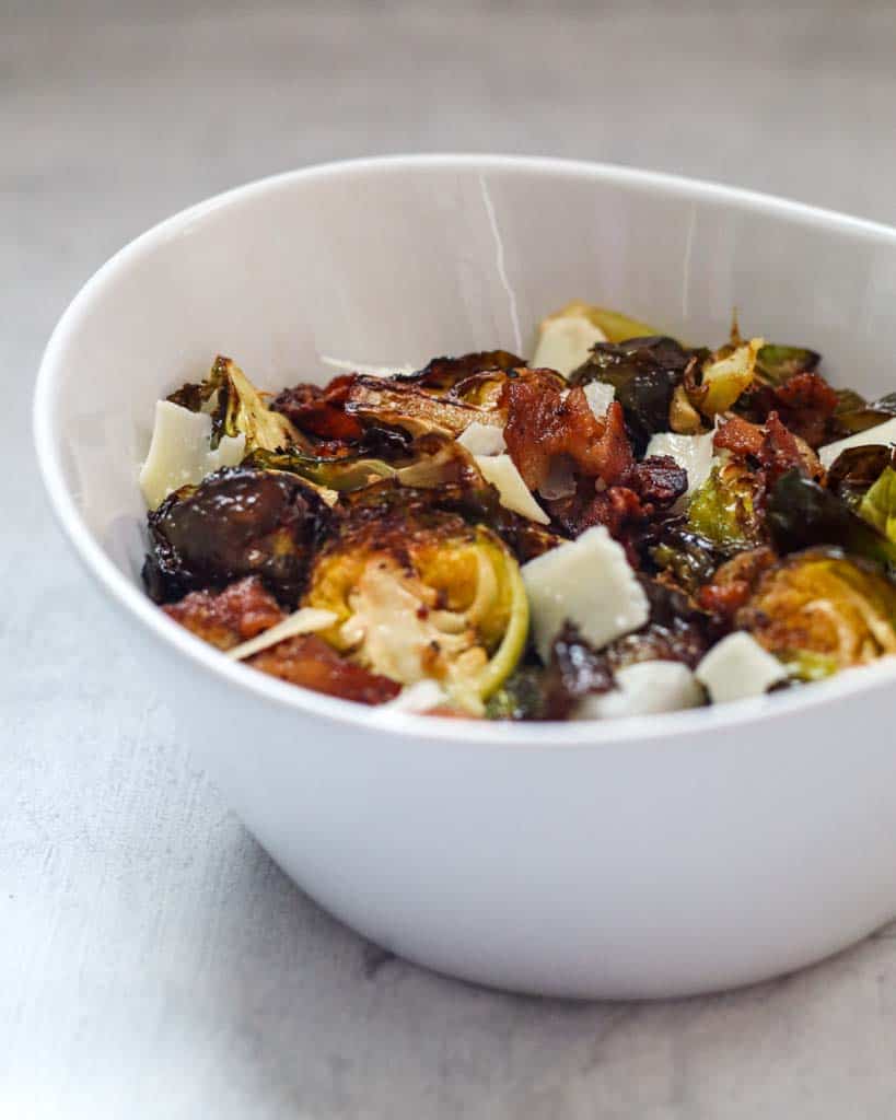 a white bowl full of brussel sprouts