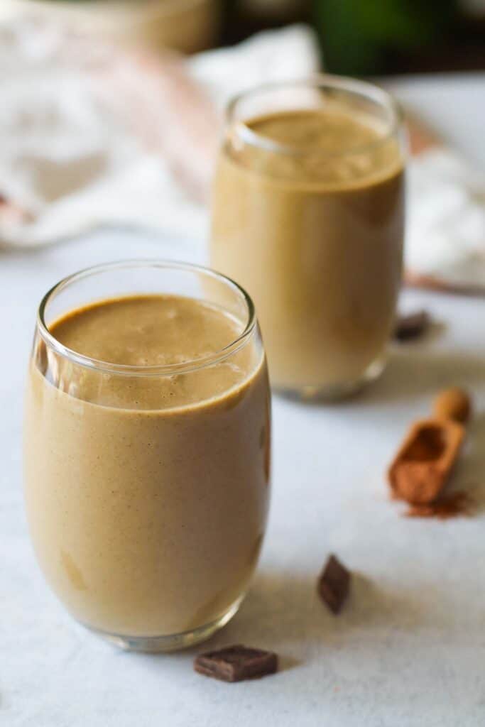 two glasses of a creamy chocolate smoothie 