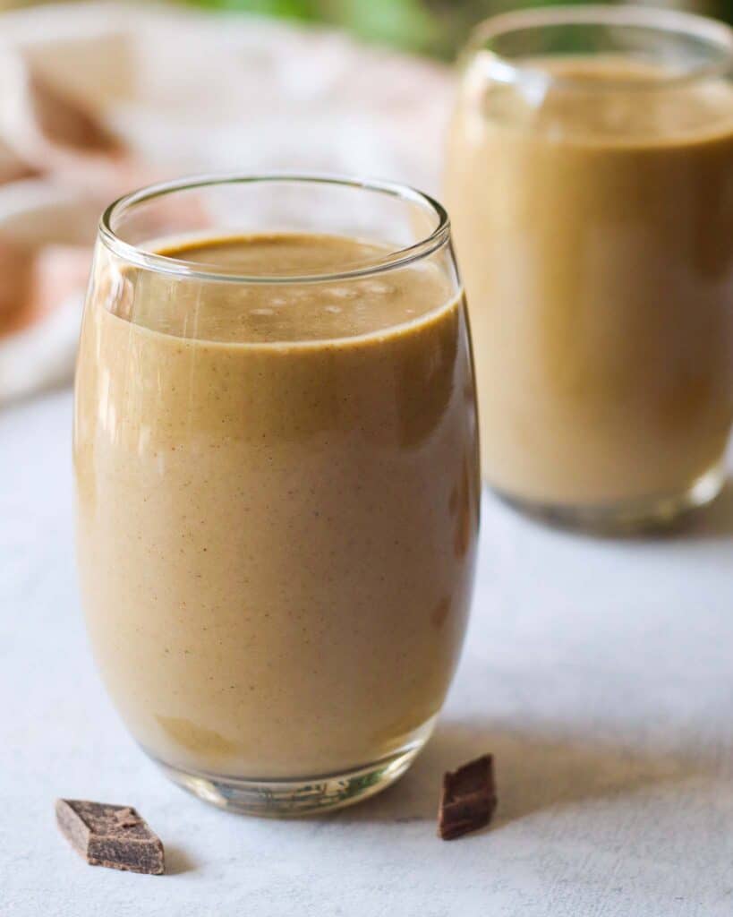 two glasses of a creamy chocolate smoothie