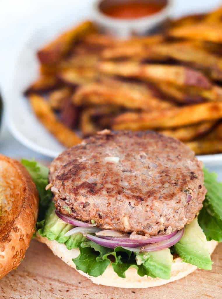 gluten free burger on a gluten free bun served with sweet potato fries