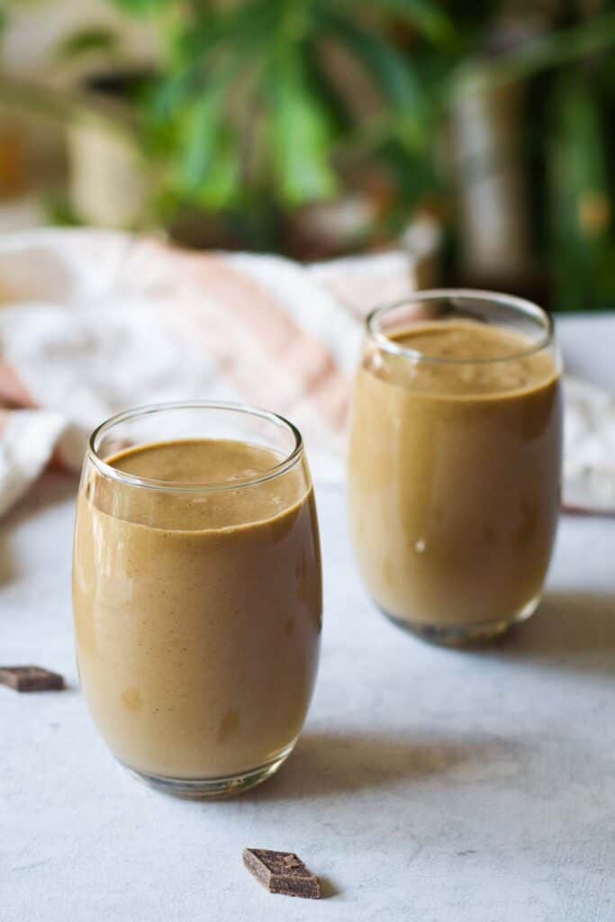 two glasses of a creamy chocolate smoothie