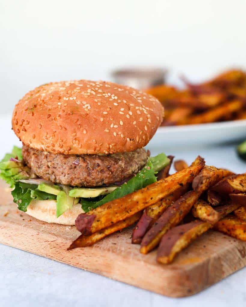 gluten free burger on a gluten free bun served with sweet potato fries