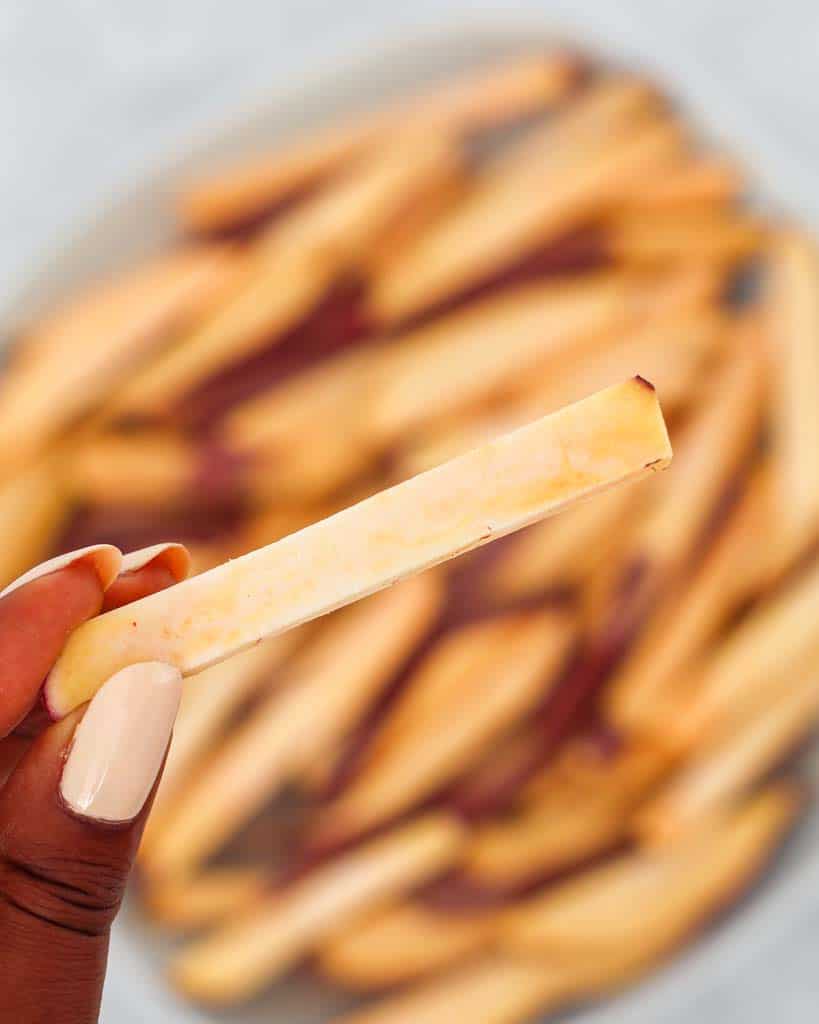 sliced sweet potato to resemeble french fry close up to show size