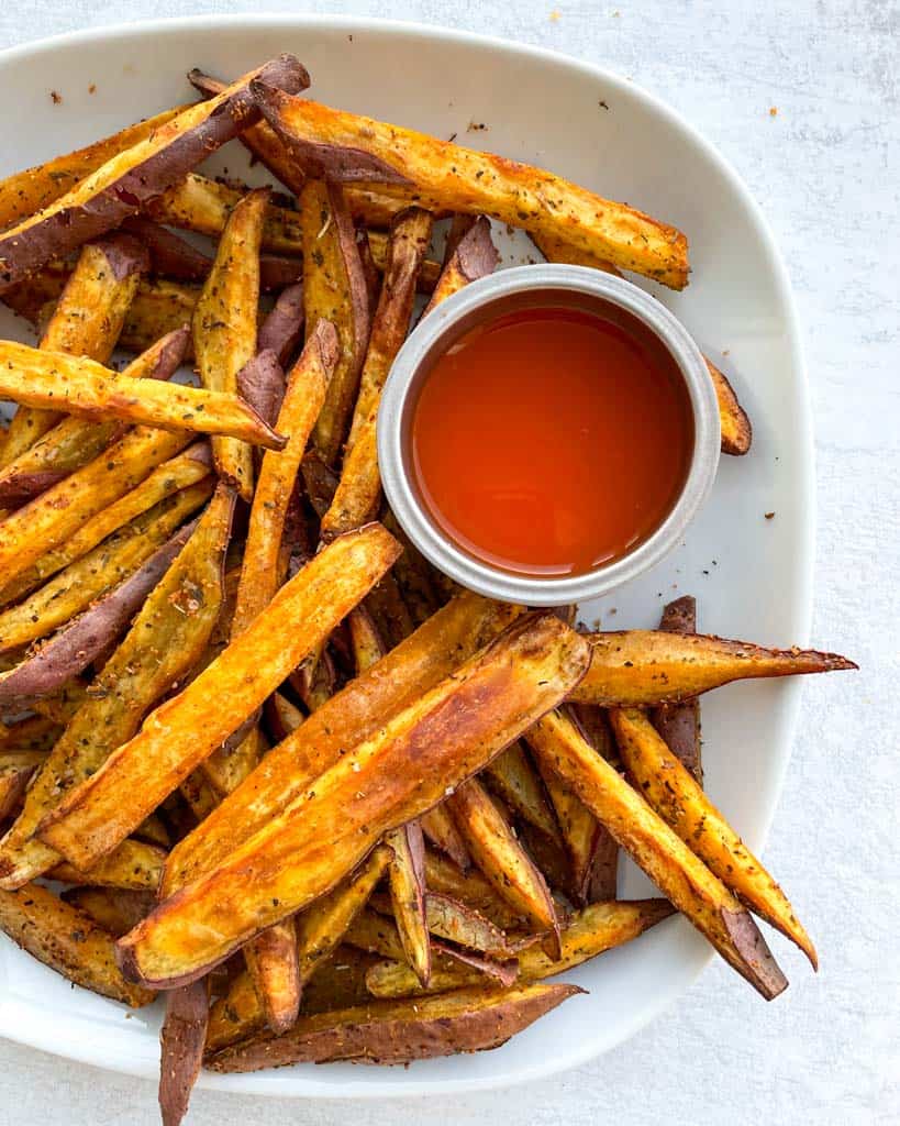 plate of sweet potato fries with ketchup on the side