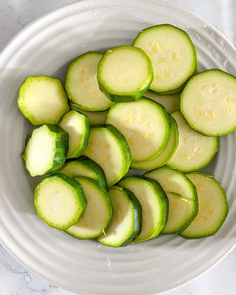 a plate of zucchini cut into rounds
