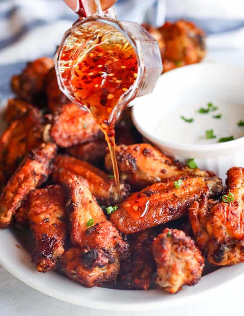 hot honey being poured over wings
