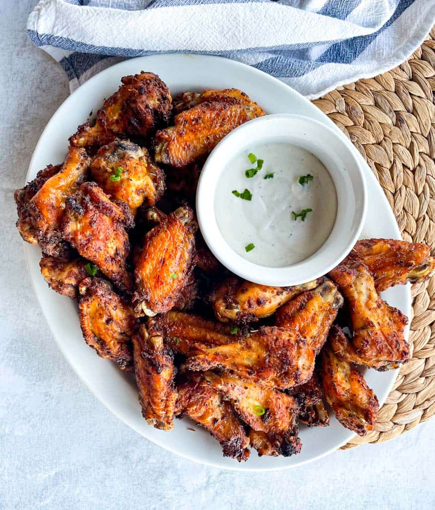 overhead view of a platter of wings with ranch dip
