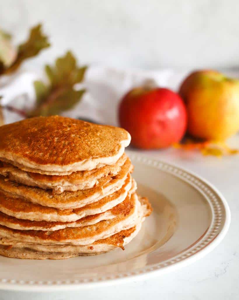 seven cinnamon apple pancakes on a white plate