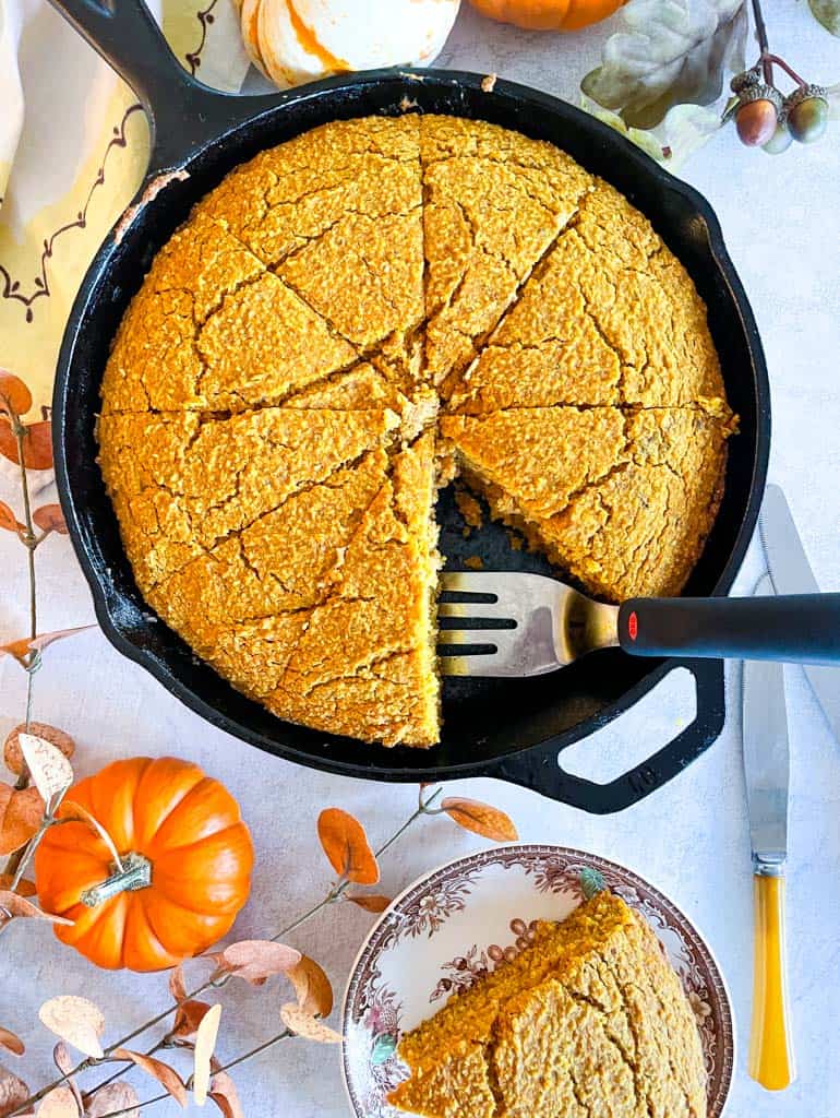 overhead view of sliced pumpkin cornbread with one piece missing